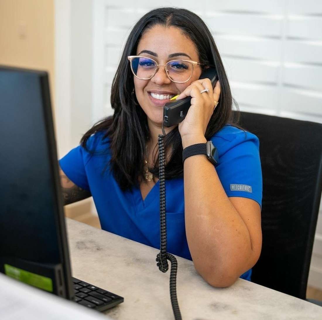 Woman answering phone at front desk of all dental tampa palms